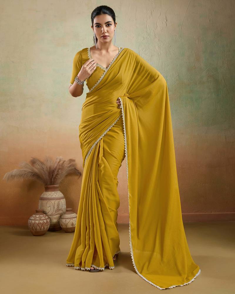 Mustard georgette embellished saree with unstitched blouse piece