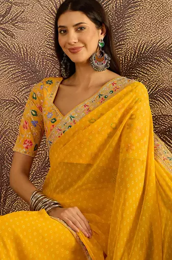 Georgette yellow bandhni saree with unstitched blouse piece