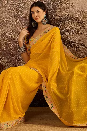 Georgette yellow bandhni saree with unstitched blouse piece
