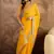 Georgette yellow bandhni saree with unstitched blouse piece