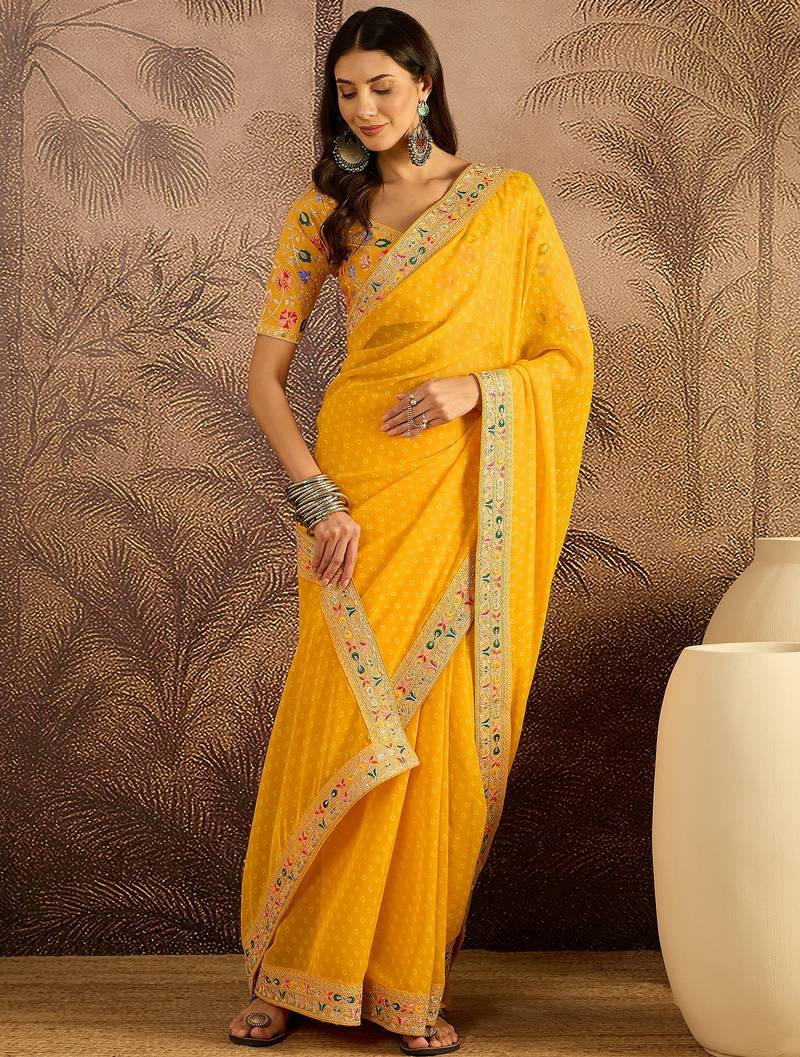 Georgette yellow bandhni saree with unstitched blouse piece