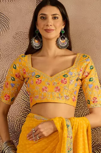 Georgette yellow bandhni saree with unstitched blouse piece