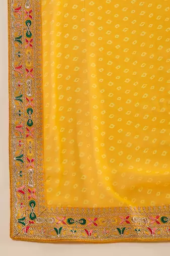 Georgette yellow bandhni saree with unstitched blouse piece