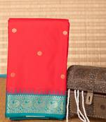 Milagai pazham and teal green small border semi silk saree