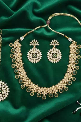 Gold plated traditional kundan-style necklace set with earrings & maangtikka