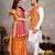 Elegant men's kurta with jacquard silk koti & women's orange saree set
