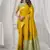 Yellow soft silk saree with elegant fancy pom-pom pallu