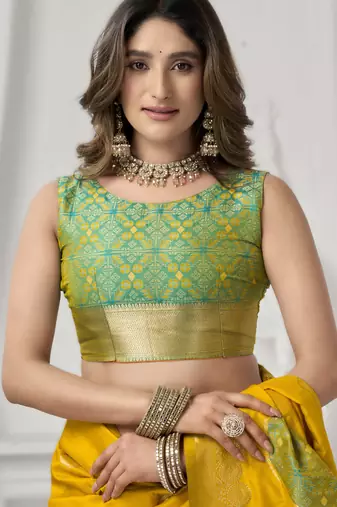 Yellow soft silk blend saree with elegant fancy pom-pom pallu