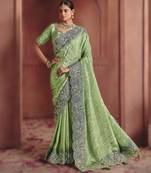 Green elegant zari dola jaquard saree with heavy embroidery and sequins
