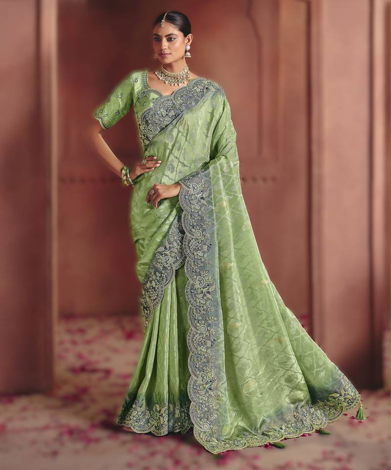 Green elegant zari dola jaquard saree with heavy embroidery and sequins