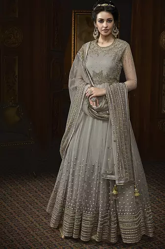 Soft net anarkali party wear salwar kameez in grey color with embroidery and crystal stone work