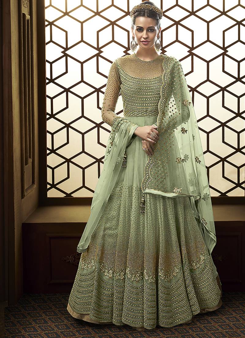 Soft net anarkali party wear salwar kameez in green color with embroidery and crystal stone work