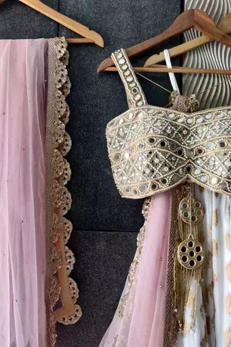 white banarasi georgette lehenga choli with gold motifs