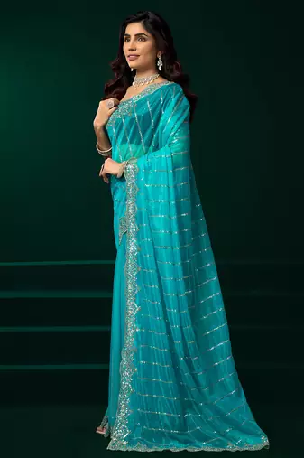 Turquoise blue net shimmering lines sequence embroidery party wear saree