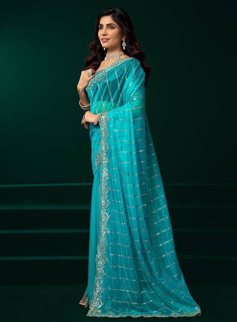 Turquoise blue net shimmering lines sequence embroidery party wear saree