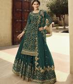 Soft premium net wedding wear sharara in teal green color with embroidery work