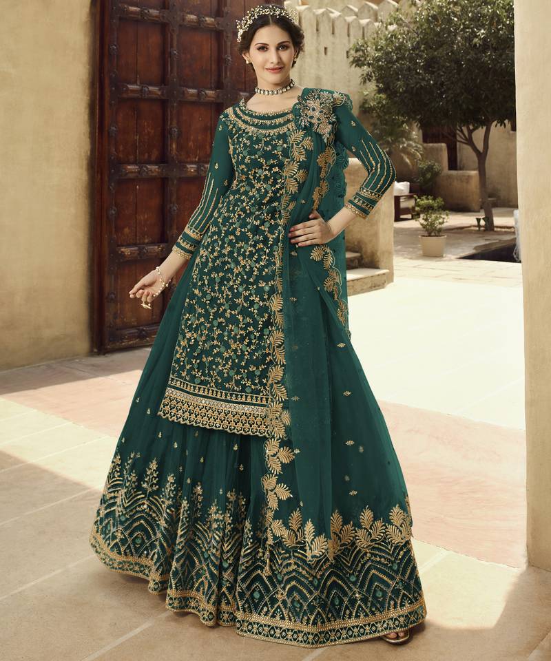 Soft premium net wedding wear sharara in teal green color with embroidery work