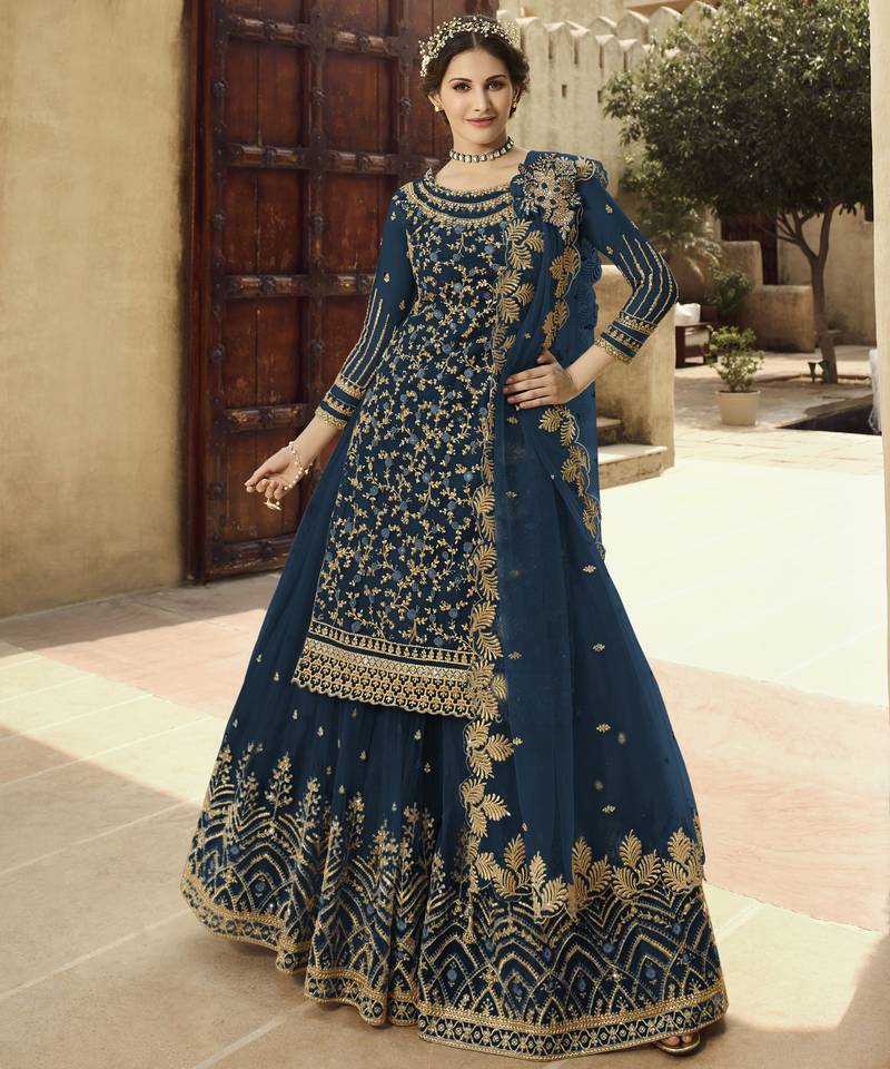Soft premium net wedding wear sharara in teal blue color with embroidery work