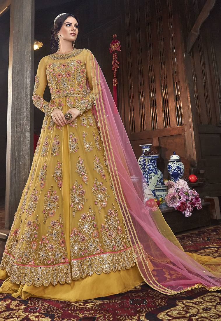 Soft premium net wedding wear gown in yellow color with embroidery work