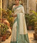 Ivory and sea green banarasi silk saree with golden zari     regal elegance for timeless celebrations