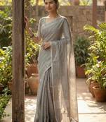 Elegant grey woven linen saree with contrast zari border & tassels     soft & breathable party wear