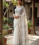 Elegant white woven linen saree with contrast zari border & tassels     soft & breathable party wear