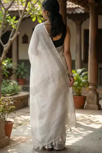 Elegant white woven linen saree with contrast zari border & tassels     soft & breathable party wear