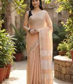 Elegant tan woven linen saree with contrast zari border & tassels     soft & breathable party wear