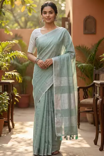 Elegant sea green woven linen saree with contrast zari border & tassels     soft & breathable party wear