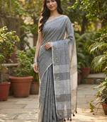 Elegant dark grey woven linen saree with contrast zari border & tassels     soft & breathable party wear