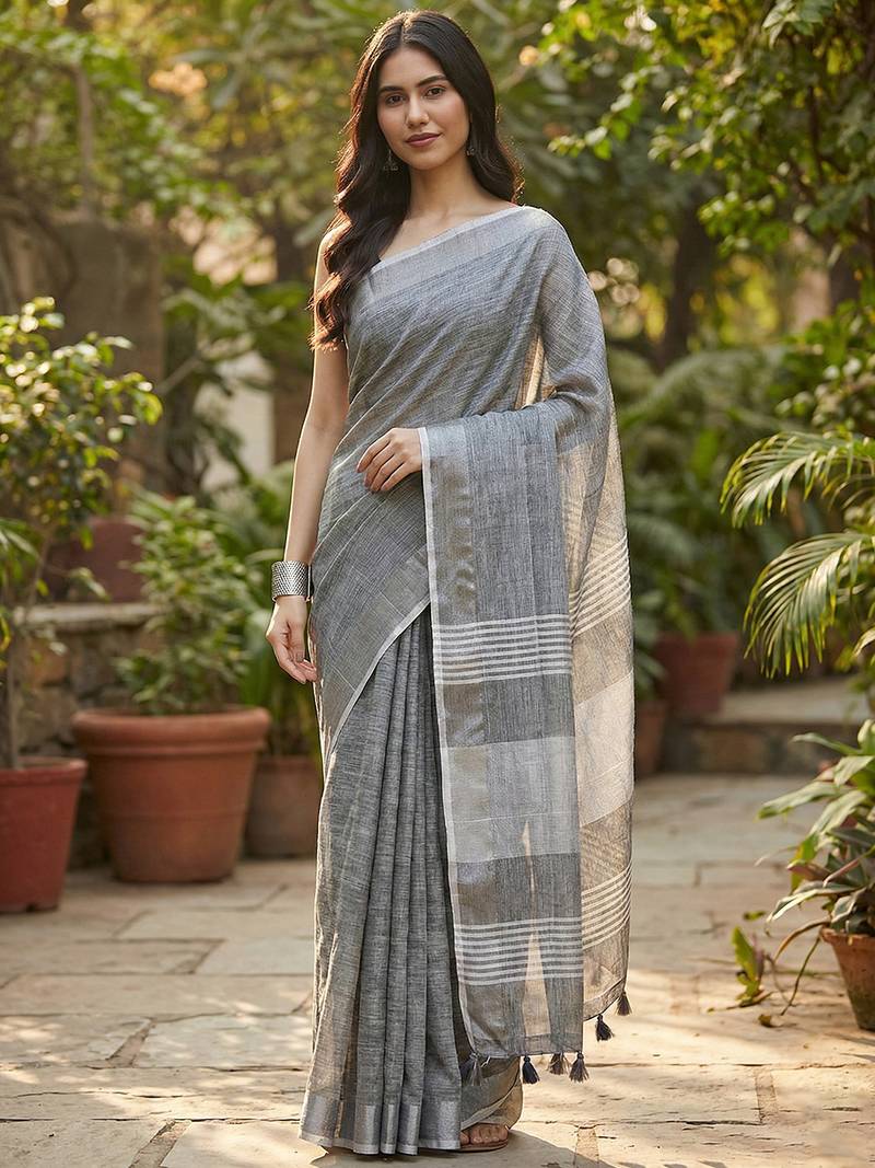 Elegant dark grey woven linen saree with contrast zari border & tassels     soft & breathable party wear