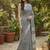 Elegant dark grey woven linen saree with contrast zari border & tassels     soft & breathable party wear