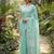 Elegant turquoise woven linen saree with contrast zari border & tassels     soft & breathable party wear