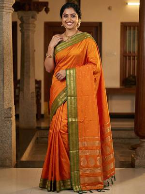 The sunset glow: vibrant orange soft silk blend saree with contrast green zari border 1