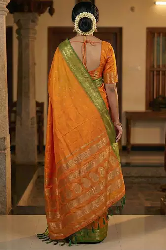 The sunset glow: vibrant orange soft silk blend saree with contrast green zari border
