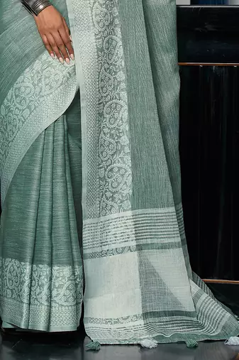 Women teal green & silver-toned woven design linen blend saree