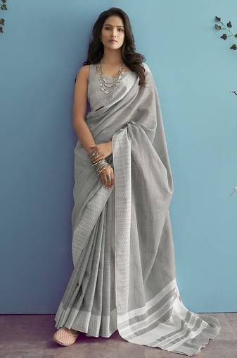 Women teal green & silver-toned woven design linen blend saree