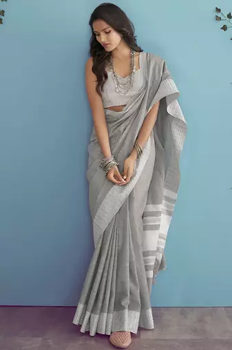 Women teal green & silver-toned woven design linen blend saree
