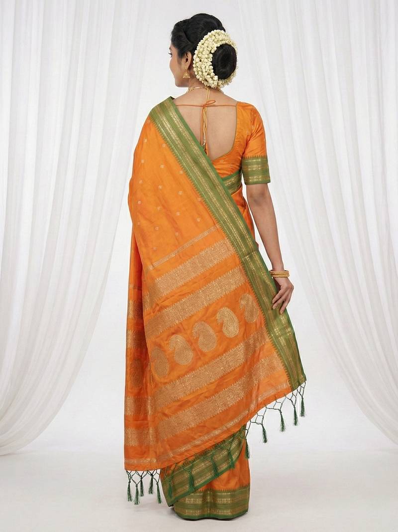 the sunset glow: vibrant orange soft silk blend saree with contrast green zari border
