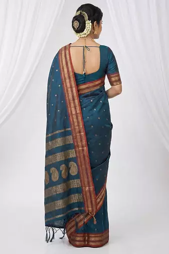 the peacock hue: teal blue soft silk blend saree with contrast red zari border