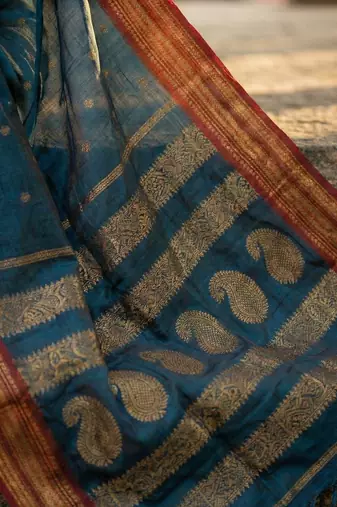 The peacock hue: teal blue soft silk blend saree with contrast red zari border