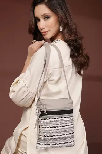 grey acrylic sling bag with striped pattern