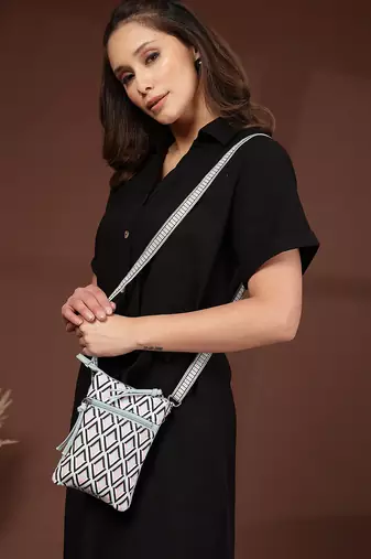 teal canvas sling bag with geometric print
