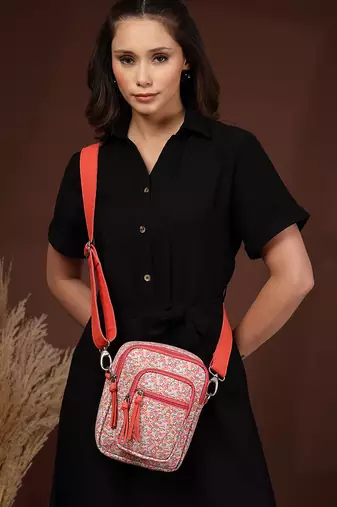 red canvas sling bag with floral print