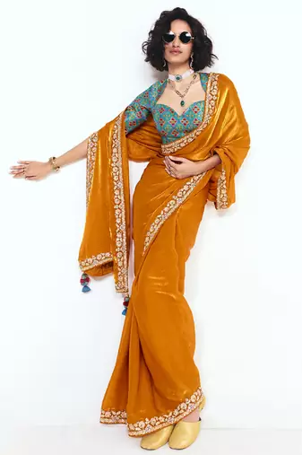 Orange fancy beautified with sequins dhaga thread embroidered work saree