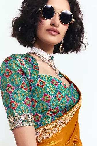 Orange fancy beautified with sequins dhaga thread embroidered work saree