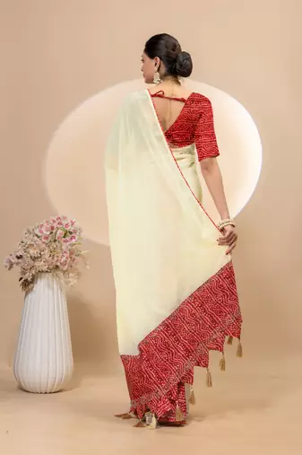 Cream georgette saree with siroski work and bandhni print pallu and blouse