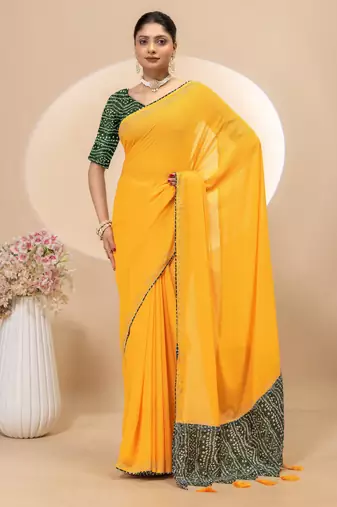 Yellow georgette saree with siroski work and bandhni print pallu and blouse