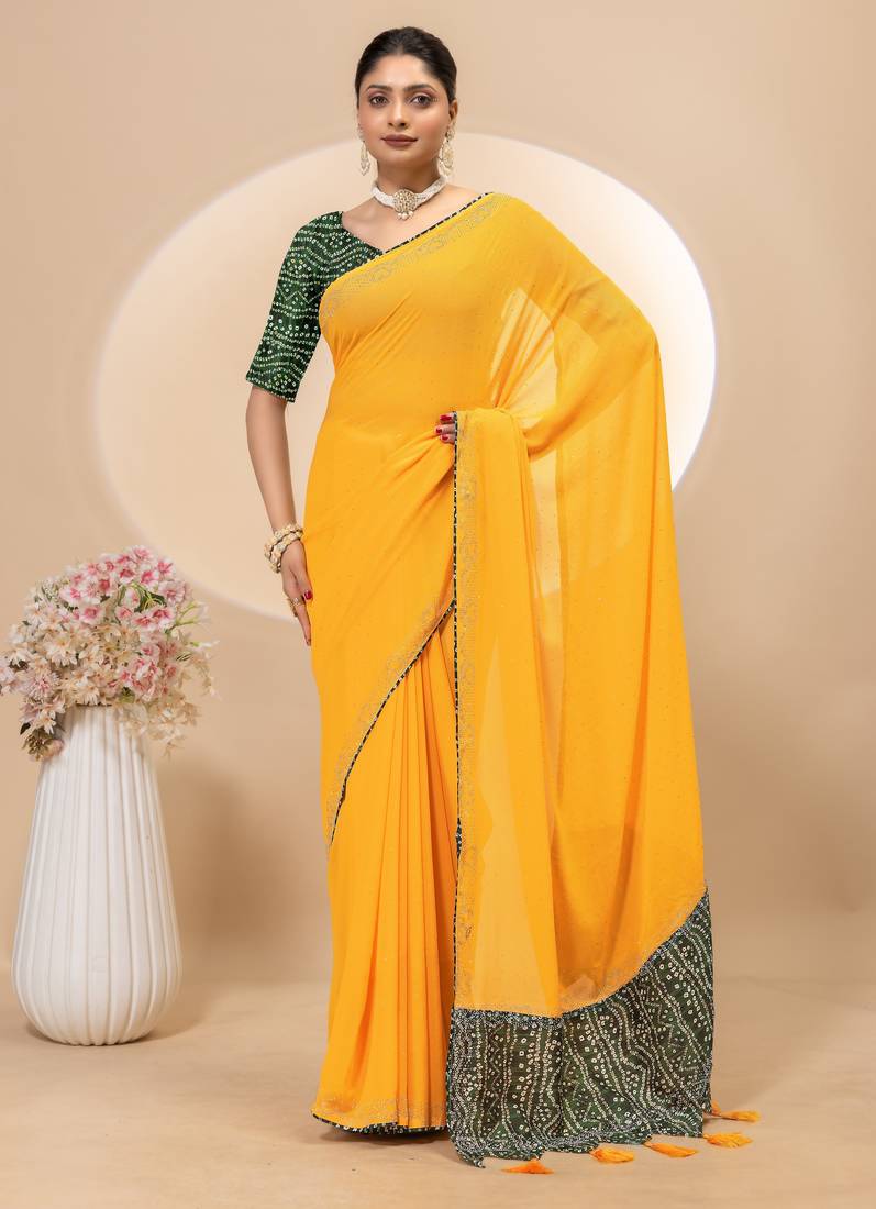 Yellow georgette saree with siroski work and bandhni print pallu and blouse