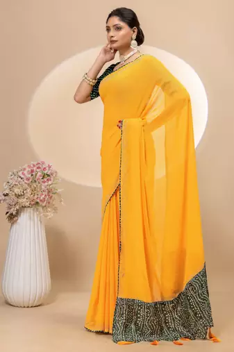 Yellow georgette saree with siroski work and bandhni print pallu and blouse